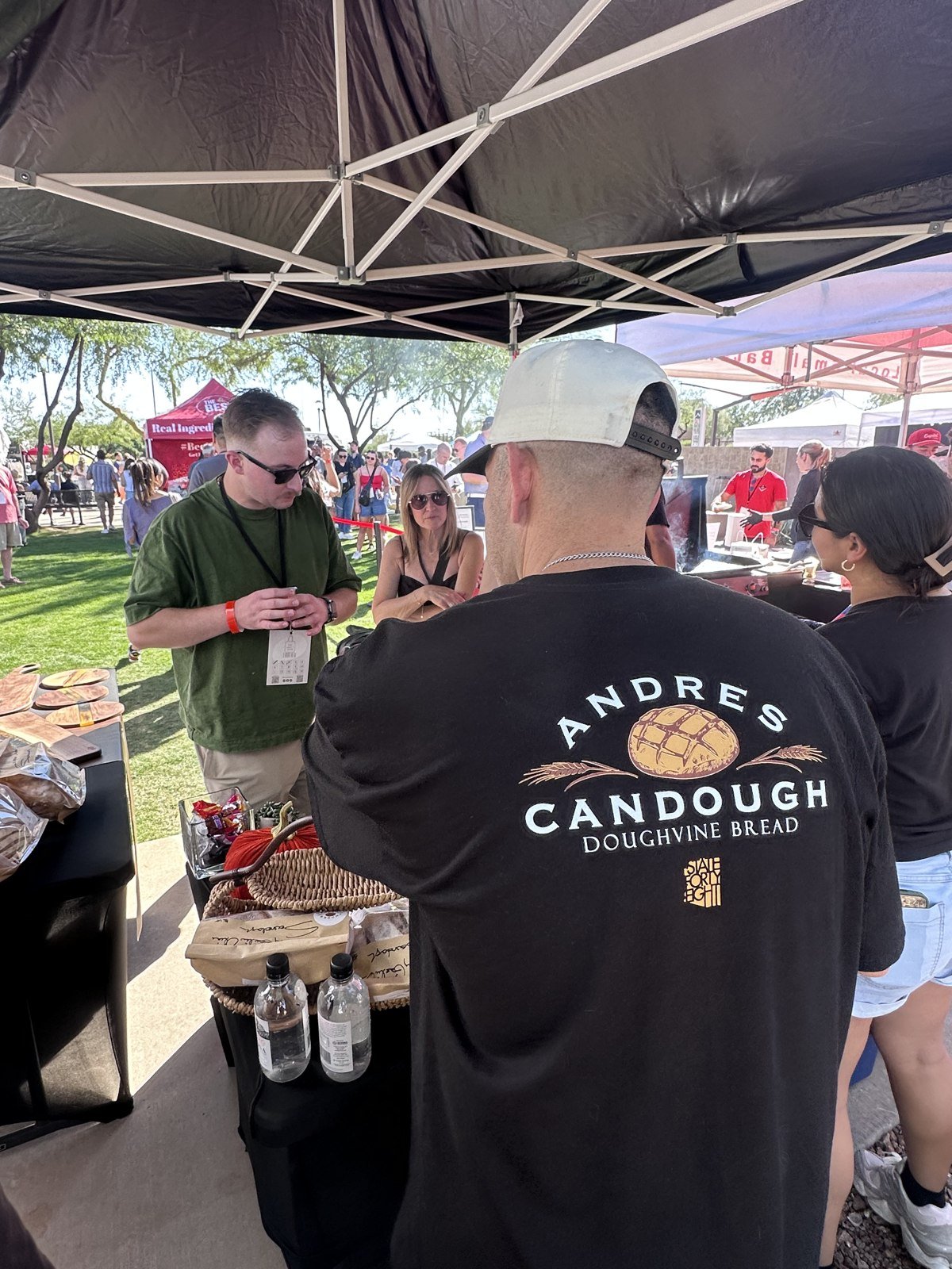 Andres sharing bread at an outdoor market